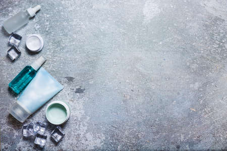 Cosmetics on a concrete background with ice cubesの写真素材