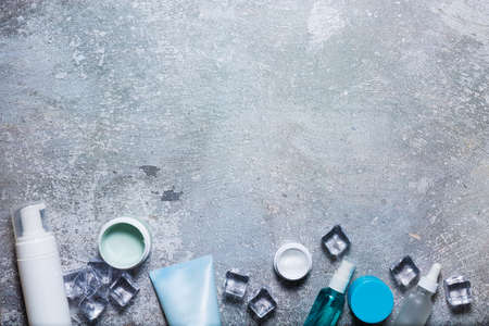 Cosmetics on a concrete background with ice cubesの写真素材