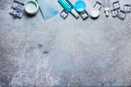 Cosmetics on a concrete background with ice cubesの写真素材