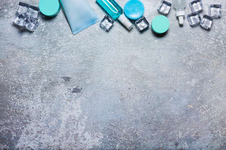 Cosmetics on a concrete background with ice cubesの写真素材