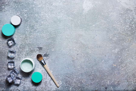 Cosmetics on a concrete background with ice cubesの写真素材