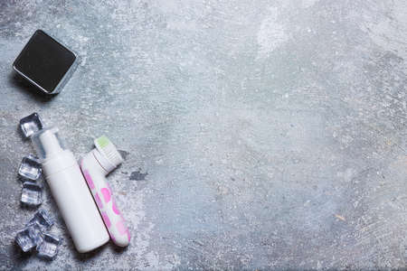 Cosmetics on a concrete background with ice cubesの写真素材