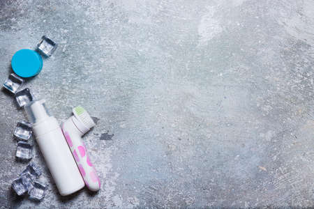 Cosmetics on a concrete background with ice cubesの写真素材