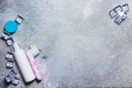 Cosmetics on a concrete background with ice cubesの写真素材