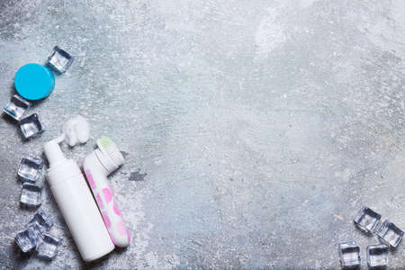 Cosmetics on a concrete background with ice cubesの写真素材