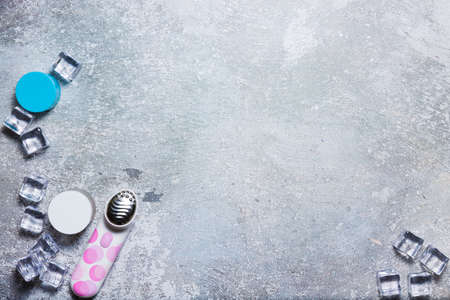Cosmetics on a concrete background with ice cubesの写真素材