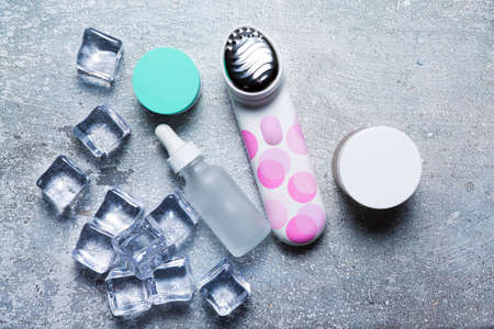 Cosmetics on a concrete background with ice cubesの写真素材
