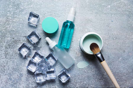 Cosmetics on a concrete background with ice cubesの写真素材