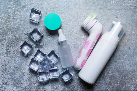 Cosmetics on a concrete background with ice cubesの写真素材