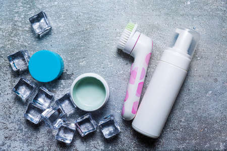 Cosmetics on a concrete background with ice cubesの写真素材