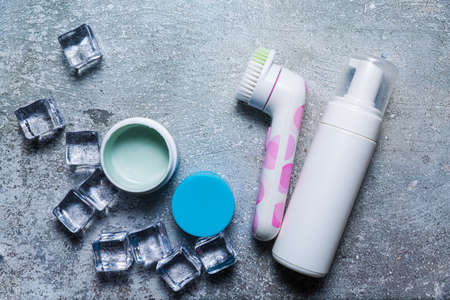 Cosmetics on a concrete background with ice cubesの写真素材