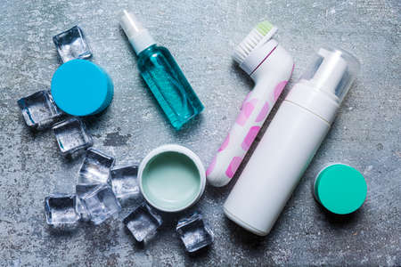 Cosmetics on a concrete background with ice cubesの写真素材