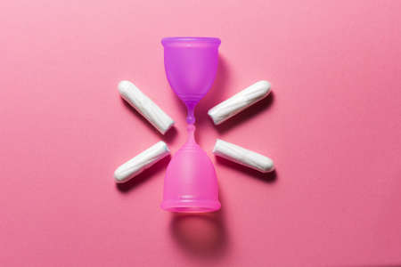 Feminine hygiene products on bright pink background. Menstruation conceptの写真素材
