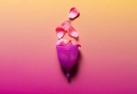 Feminine hygiene products on bright pink background. Menstruation conceptの写真素材