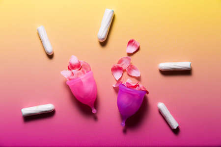 Feminine hygiene products on bright pink background. Menstruation conceptの写真素材