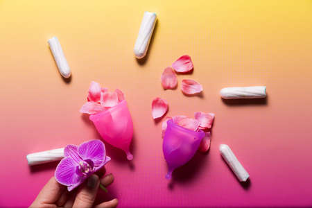 Feminine hygiene products on bright pink background. Menstruation conceptの写真素材