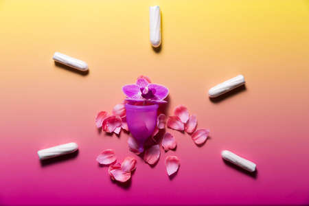 Feminine hygiene products on bright pink background. Menstruation conceptの写真素材