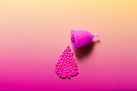 Feminine hygiene products on bright pink background. Menstruation conceptの写真素材