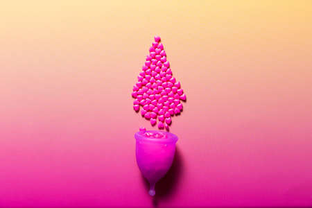 Feminine hygiene products on bright pink background. Menstruation conceptの写真素材