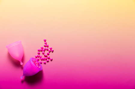 Feminine hygiene products on bright pink background. Menstruation conceptの写真素材