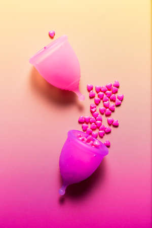 Feminine hygiene products on bright pink background. Menstruation conceptの写真素材