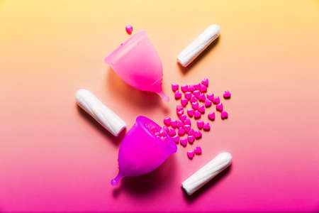 Feminine hygiene products on bright pink background. Menstruation conceptの写真素材