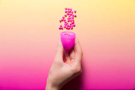Feminine hygiene products on bright pink background. Menstruation conceptの写真素材