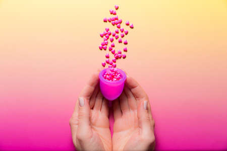 Feminine hygiene products on bright pink background. Menstruation conceptの写真素材