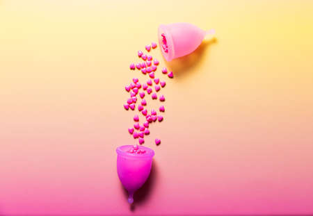 Feminine hygiene products on bright pink background. Menstruation conceptの写真素材