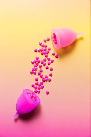 Feminine hygiene products on bright pink background. Menstruation conceptの写真素材