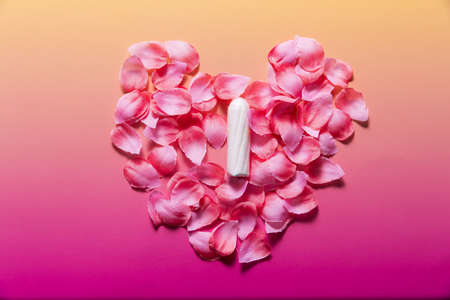 Feminine hygiene products on bright pink background. Menstruation conceptの写真素材