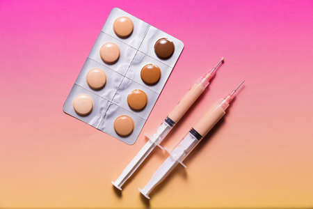 Pills in a blister pack and syringes filled with makeup concealer and foundation. Perfect skin conceptの写真素材