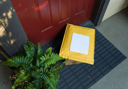 A box and a mailer on a doorstep, online order home delivery concept