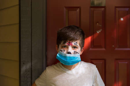 Boy with Halloween makeup wearing a surgical maskの写真素材