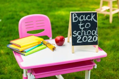 Desk with a stack of school supplies. Back to school 2020の写真素材
