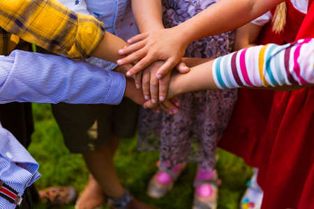 Kids standing in the circle and joining hands togetherの写真素材
