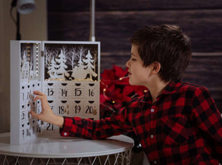 Boy counting day till Christmas with an advent calendarの写真素材