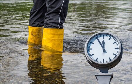 Wellies in the flood with clockの写真素材