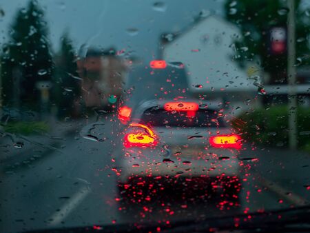Heavy rain on the windshield with brake light