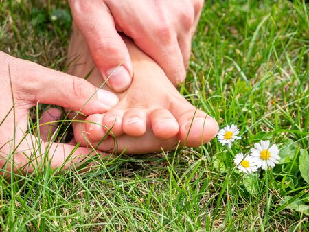 Pleasant foot massage in a meadowの写真素材