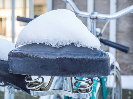 Bicycle saddle with snowの写真素材