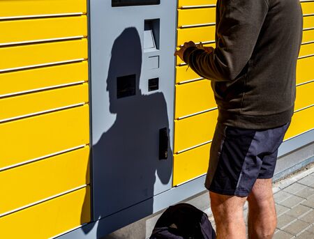 Man at a packing station picking up packages