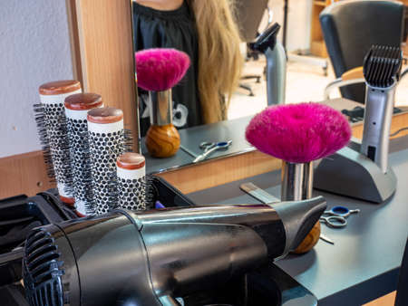 Hair salon Blonde woman cutting hair in salonの写真素材