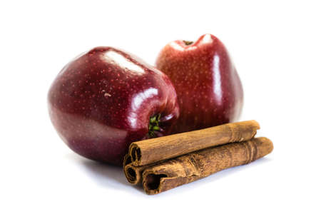 apple with cinnamon sticks isolated on white backgroundの写真素材
