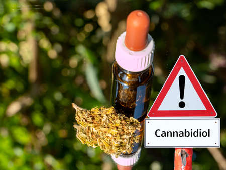 bottle with CBD oil medical cannabis warning sign