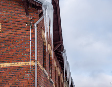 Icicles hang on the roof - mortal dangerの写真素材