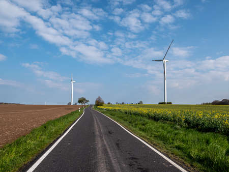 Country road with a wind turbine New goals