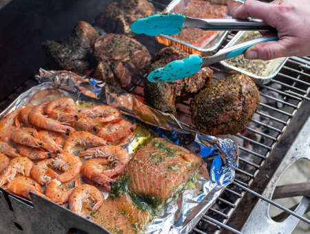 Meat roast and fish on the charcoal grill