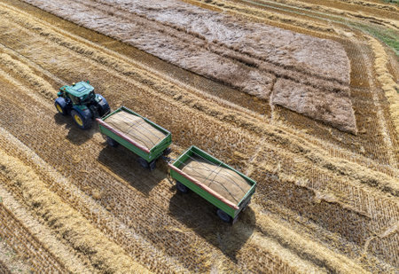 Aerial view of tractor harvesting a grain field