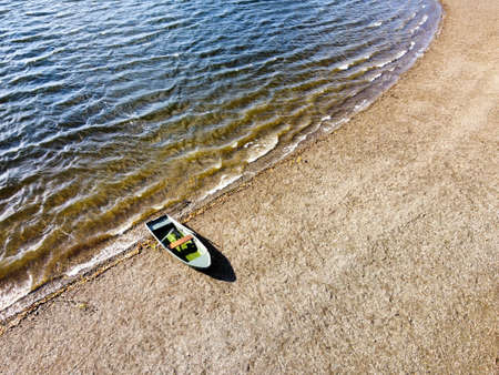 lonely boat on a beachの写真素材